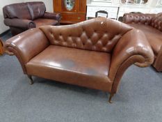 A brown leather Chesterfield style buttoned back chaise longue