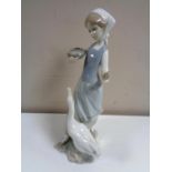 A Lladro figure of a lady with goose.