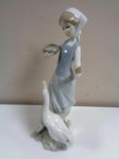 A Lladro figure of a lady with goose.