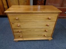 A pine four drawer chest