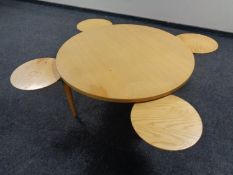 An early 20th century circular coffee table with retractable trays by Getama