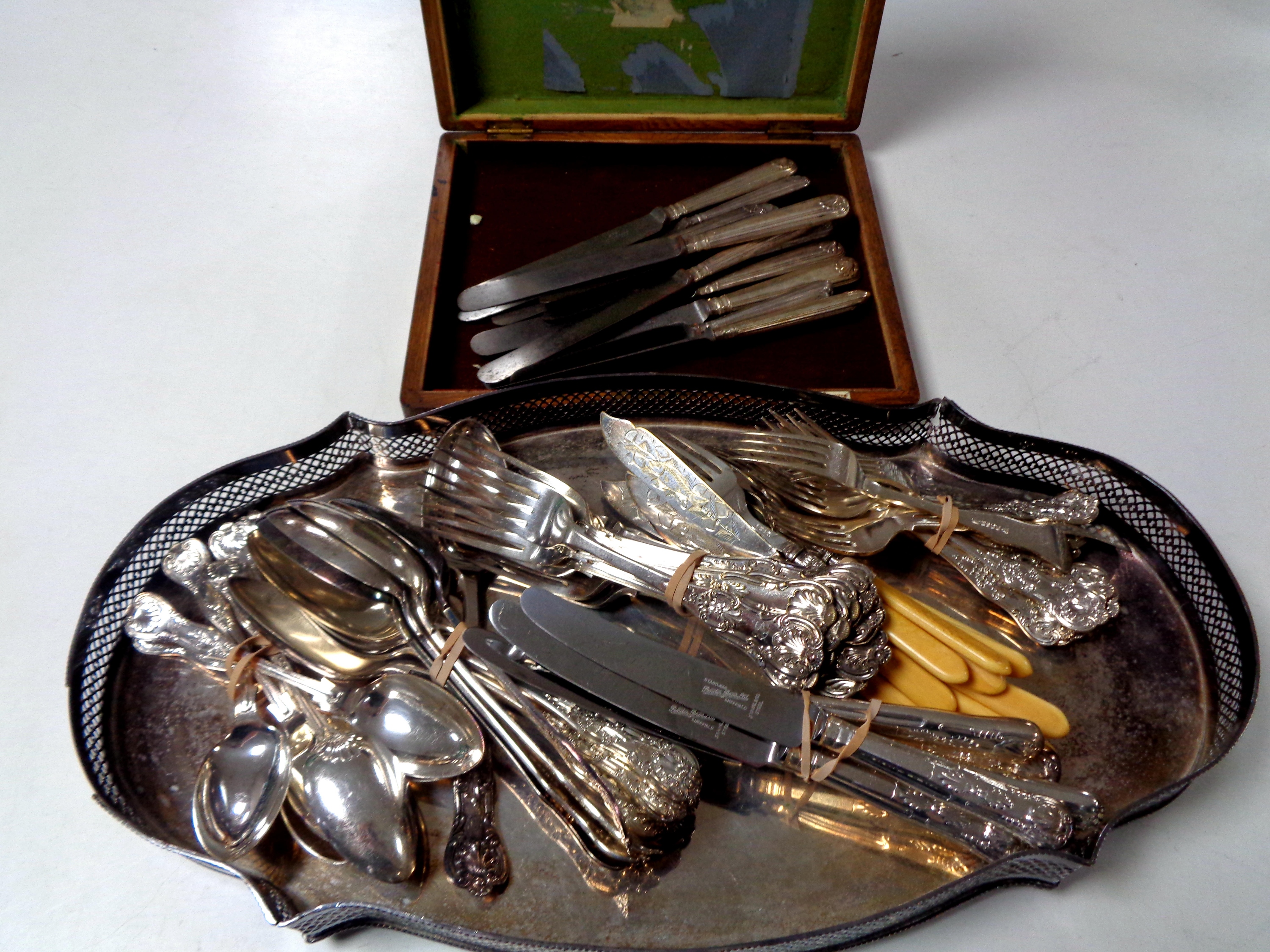 An Edwardian cutlery canteen together with a silver plated serving tray and a quantity of plated