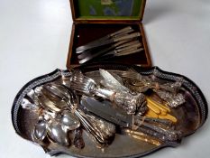 An Edwardian cutlery canteen together with a silver plated serving tray and a quantity of plated