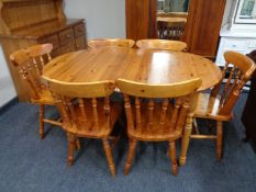 An eight piece pine dining room suite comprising of triple door Welsh dresser,