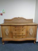 An early 20th century continental oak Queen Anne style sideboard