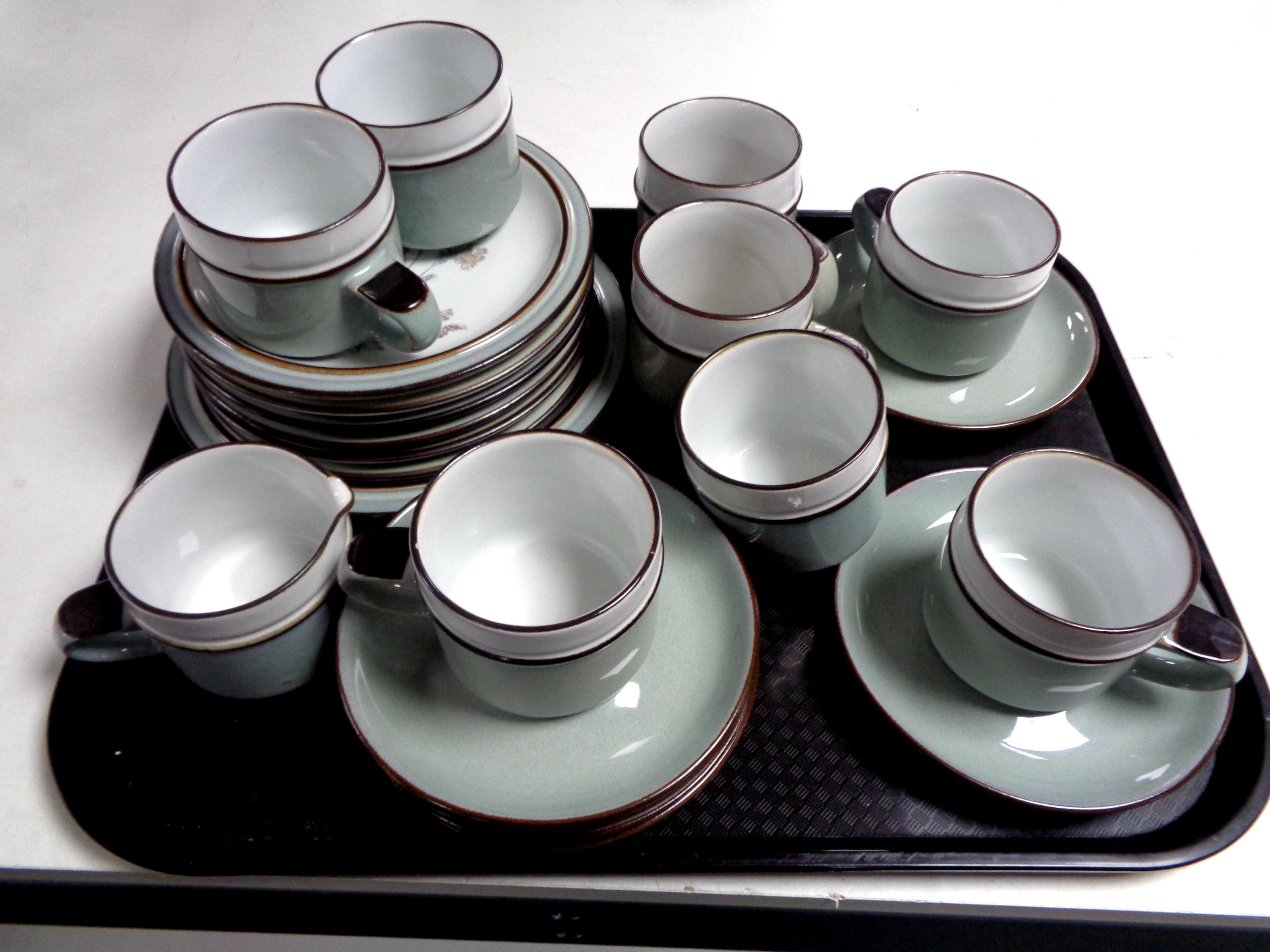 A tray of twenty two pieces of Denby pottery tea ware