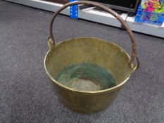 A brass jam pan with cast iron handle