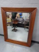 A large contemporary hardwood overmantel mirror