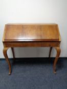 An early 20th century mahogany writing bureau on cabriole legs