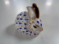 A Royal Crown Derby rabbit paperweight with gold stopper.