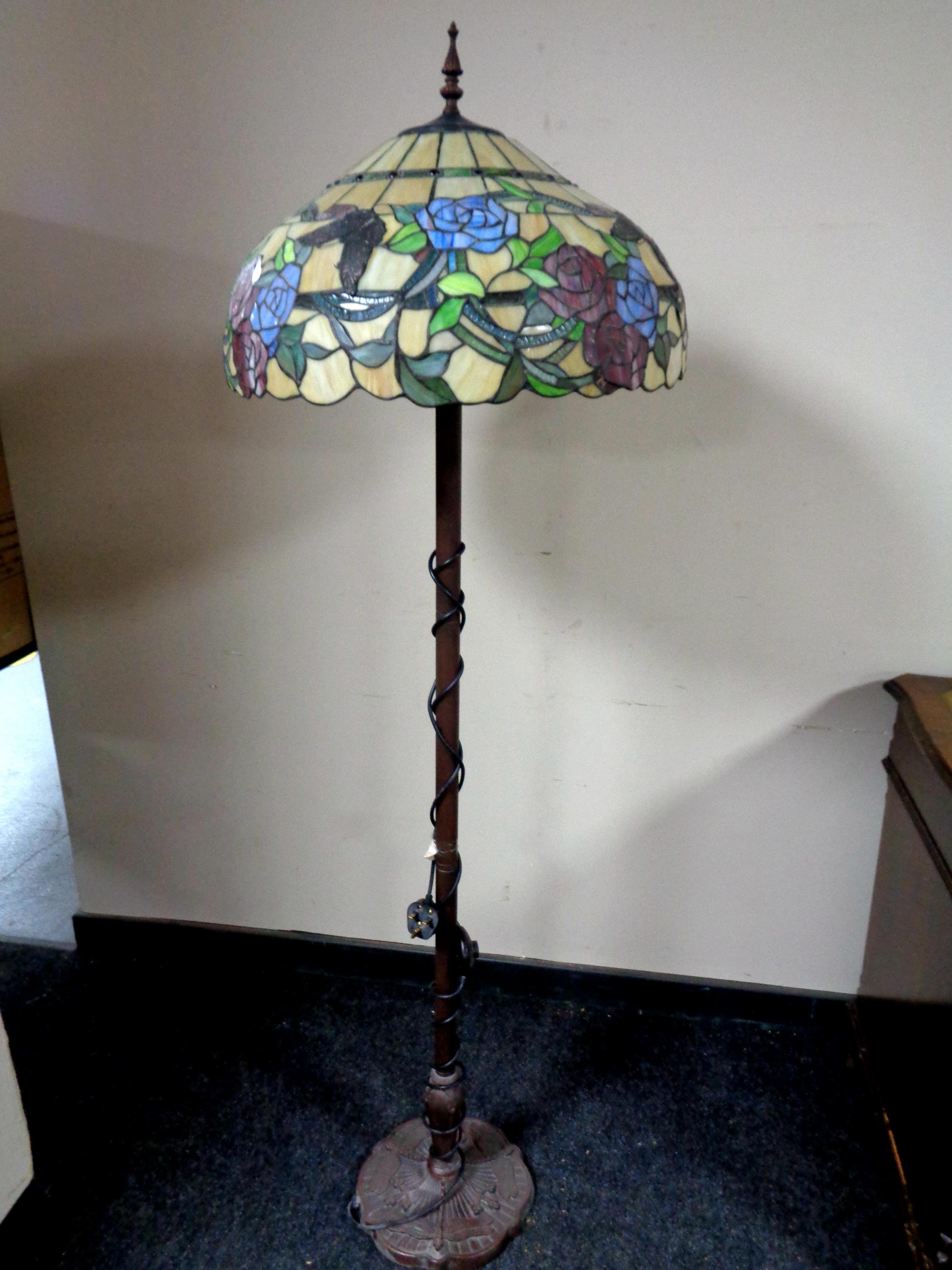 A Tiffany style standard lamp with leaded glass shade