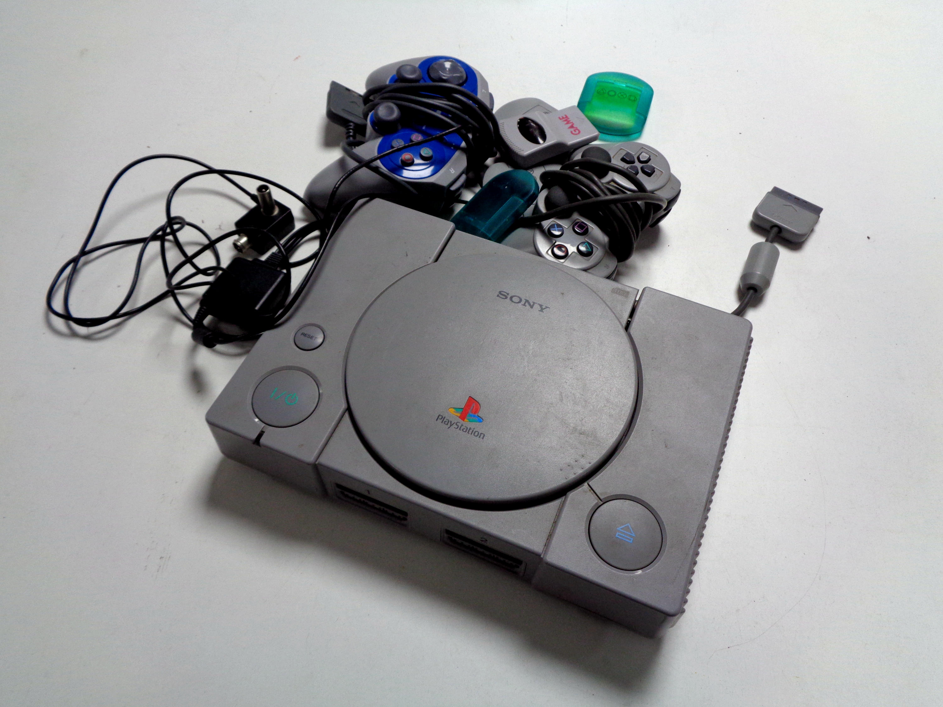 A Sony Playstation with controllers,