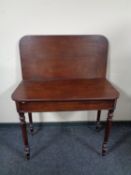 A 19th century mahogany turnover top tea table