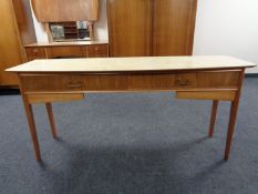 A mid 20th century two drawer flap sided console table with melamine top