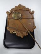 A Continental oak wall clock with pendulum and weights