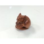 A carved Chinese hardwood netsuke - Rat sat on a nut
