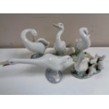 A Lladro figure group of a geese with goslings together with four further Lladro figures of geese.