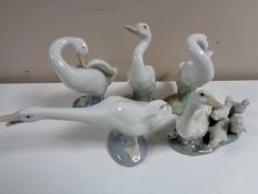 A Lladro figure group of a geese with goslings together with four further Lladro figures of geese.