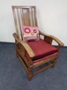 A pair of Edwardian adjustable armchairs (one lacking cushions)