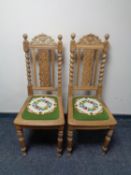 A pair of 20th century carved oak barley twist hall chairs with tapestry seats