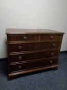 A 20th century mahogany five drawer chest on bracket feet