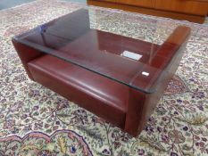 A mid 20th century glass topped coffee table on Burgundy leather base