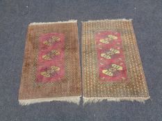 A pair of fringed geometric design rugs