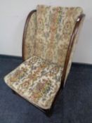 A 1930's tapestry upholstered wingback nursing chair