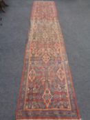 A machined floral patterned carpet runner on pink ground