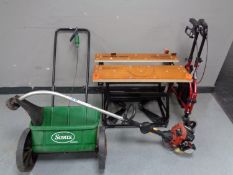 A Homelite petrol strimmer together with a Black and Decker workbench,