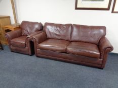 A brown leather two seater settee with matching armchair