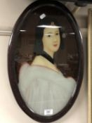 A framed portrait on glass of an oriental lady