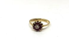 An 18ct gold ruby and diamond cluster ring, size O. CONDITION REPORT: 2.