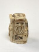 A carved Chinese bone netsuke - Village elder with staff