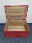 An upholstered antique pine blanket box