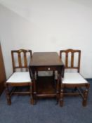 A mid 20th century flap sided two tier tea trolley together with a pair of dining chairs