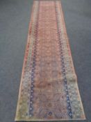 A fringed North West Persian carpet runner