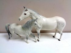 Two Royal Doulton horses.