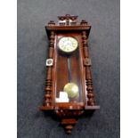 An early 20th century mahogany cased Vienna style eight day wall clock with pendulum and key
