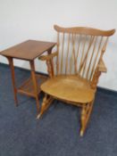 A beech spindle back rocking chair together with an Edwardian two tier occasional table