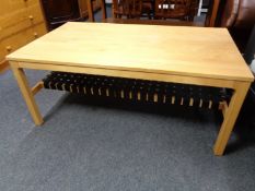 A continental pine effect coffee table with webbed strapping undershelf