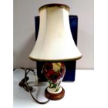 A Moorcroft table lamp with red flowers on cream ground, height of lamp base 19cm, with shade,