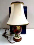 A Moorcroft table lamp with red flowers on cream ground, height of lamp base 19cm, with shade,