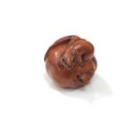 A carved Chinese hardwood netsuke - Rats eating a fruit