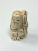 A carved Chinese bone netsuke - village elder with staff