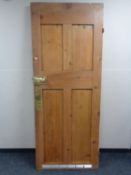 An early 20th century stripped pine four panel door