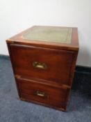 A ship's style two drawer bedside chest with a tooled leather panel top