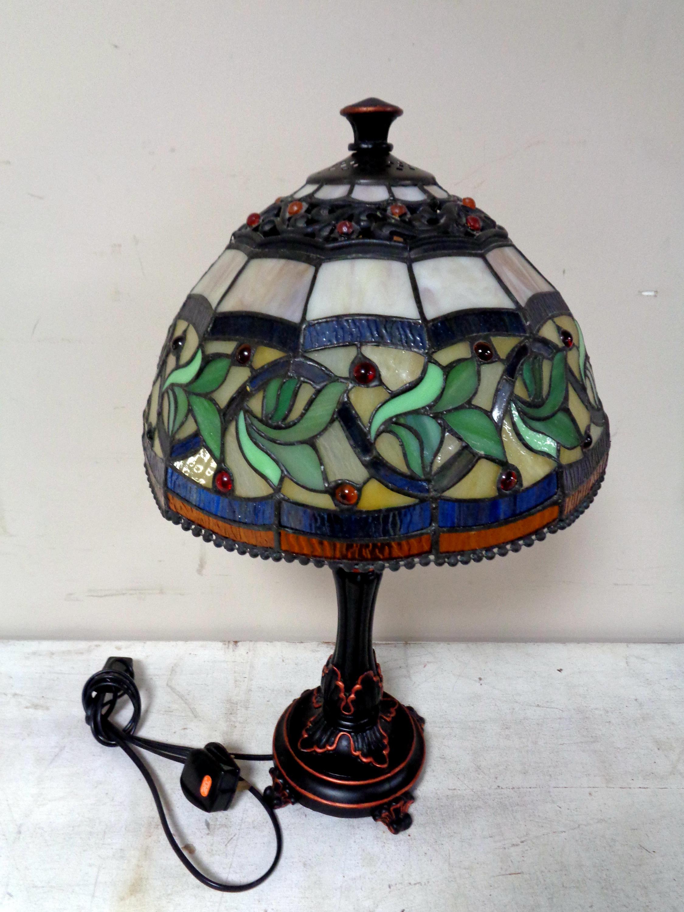 A Tiffany style table lamp with leaded glass shade