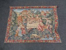 A wall tapestry depicting an Elizabethan feast in a garden