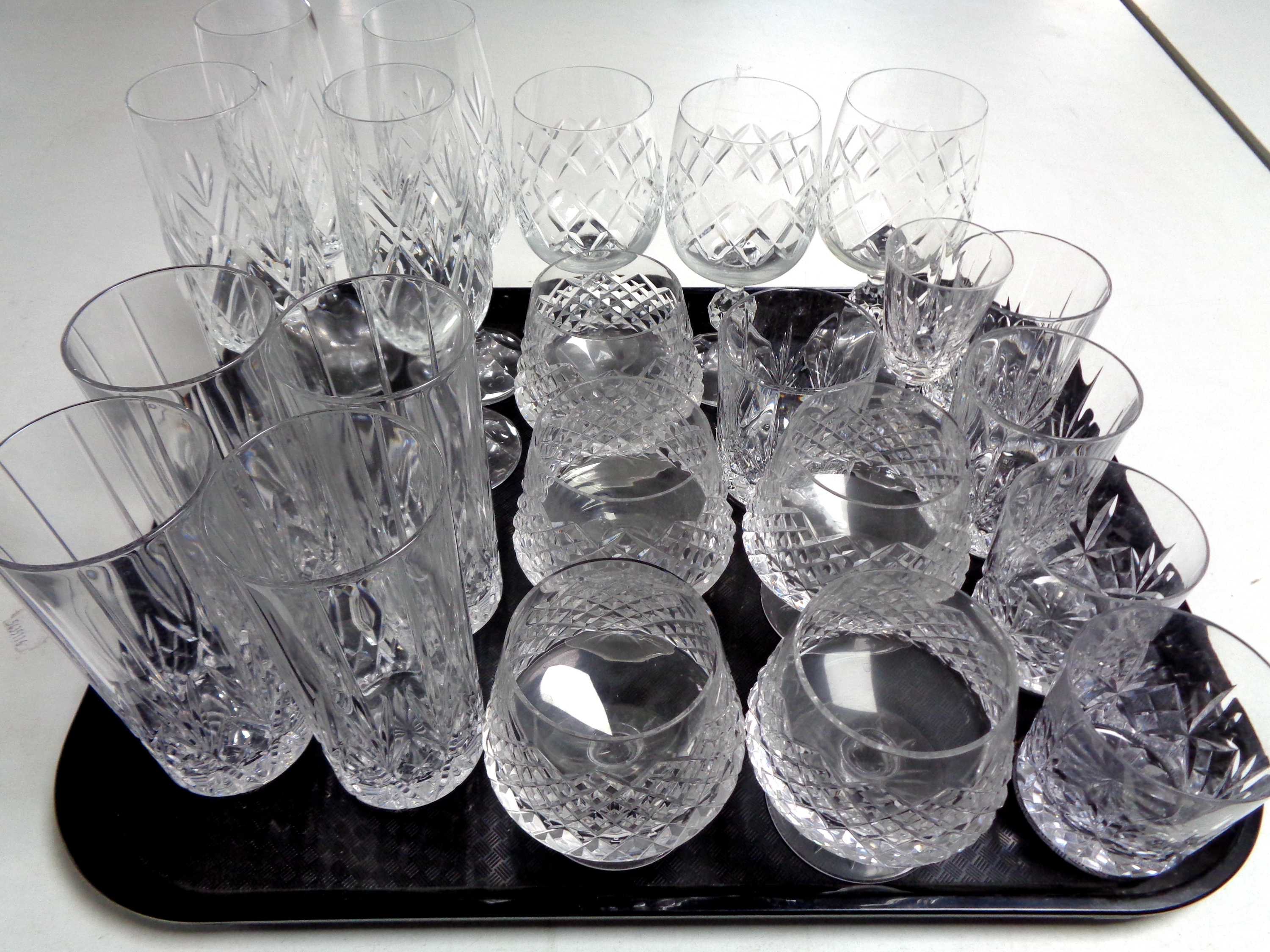 A tray of lead crystal and cut glass drinking glasses